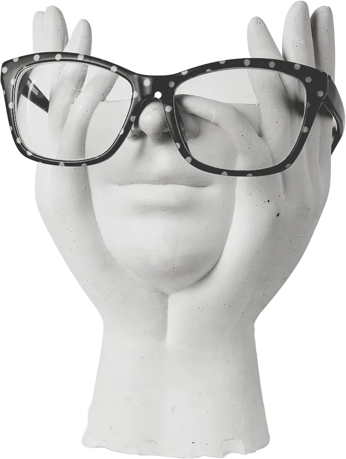 Plaster hands holding a face wearing reading glasses